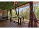 Relaxing outdoor porch with a porch swing, ceiling fan, and backyard views at 4631 Crooked Creek Ln, Villa Rica, GA 30180