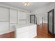 Walk-in closet with custom shelving, drawers, and a center island for storage and organization at 4631 Crooked Creek Ln, Villa Rica, GA 30180