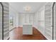 Large walk-in closet featuring hardwood floors, a center island, and custom shelving at 4631 Crooked Creek Ln, Villa Rica, GA 30180