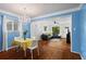 Open-concept dining area with hardwood floors, chandelier, and seamless transition to living room at 1211 Argonne Ne Way, Atlanta, GA 30324
