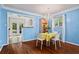 Bright dining room with chandelier, blue walls, hardwood floors, and easy access to backyard at 1211 Argonne Ne Way, Atlanta, GA 30324