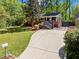 A well-maintained home with a brick facade, front porch, a long driveway, and a lush green lawn at 1211 Argonne Ne Way, Atlanta, GA 30324