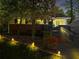 Charming home exterior illuminated at night, highlighting the brickwork, porch, and landscaped yard at 1211 Argonne Ne Way, Atlanta, GA 30324