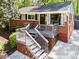 Inviting single-story home with brick facade, charming elevated porch, and well-maintained landscaping at 1211 Argonne Ne Way, Atlanta, GA 30324