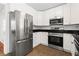 Bright kitchen features white cabinets, stainless steel appliances, and dark countertops at 1211 Argonne Ne Way, Atlanta, GA 30324