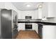 Well-lit kitchen with stainless steel appliances and sleek dark countertops at 1211 Argonne Ne Way, Atlanta, GA 30324