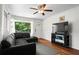 Inviting living room featuring hardwood floors, a ceiling fan, and a comfortable black leather couch at 1211 Argonne Ne Way, Atlanta, GA 30324