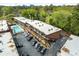 Aerial view showcasing multi-Gathering apartment complex, manicured landscape, a refreshing pool and parking area at 1705 Monroe Ne Dr # D01, Atlanta, GA 30324