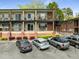 Attractive two-story apartment building showing off brick accents and open-air balconies and convenient parking at 1705 Monroe Ne Dr # D01, Atlanta, GA 30324