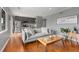 Bright living room featuring hardwood floors, gray walls, a comfortable gray sofa, and a view to the kitchen at 1705 Monroe Ne Dr # D01, Atlanta, GA 30324