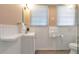 Bright bathroom with new hardwood floors, a new vanity, and walk-in shower at 1766 Sw Brewer Sw Blvd, Atlanta, GA 30310