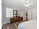 Bedroom featuring wood floors, neutral walls, and a stylish dresser at 1766 Sw Brewer Sw Blvd, Atlanta, GA 30310