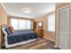 Bedroom with wood floors, natural light and comfortable bedspread at 1766 Sw Brewer Sw Blvd, Atlanta, GA 30310