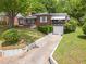 Beautifully maintained brick residence with a well-kept lawn and mature landscaping at 1766 Sw Brewer Sw Blvd, Atlanta, GA 30310