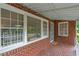 Close-up of a classic red brick house's inviting front porch at 1766 Sw Brewer Sw Blvd, Atlanta, GA 30310