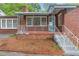 Charming red brick house with a cozy covered porch and decorative white railing at 1766 Sw Brewer Sw Blvd, Atlanta, GA 30310