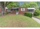 Quaint single story brick home featuring a well-manicured lawn and mature trees at 1766 Sw Brewer Sw Blvd, Atlanta, GA 30310