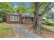 Charming red brick home shaded by a large tree at 1766 Sw Brewer Sw Blvd, Atlanta, GA 30310