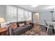Cozy living room featuring lots of natural light, a comfortable sofa, and hardwood floors at 1766 Sw Brewer Sw Blvd, Atlanta, GA 30310