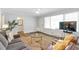 Comfortable living room featuring hardwood floors, large windows, and neutral paint at 1766 Sw Brewer Sw Blvd, Atlanta, GA 30310