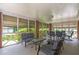 Inviting screened porch with brick columns offers a relaxing space with comfortable seating and outdoor dining area at 1766 Sw Brewer Sw Blvd, Atlanta, GA 30310