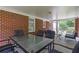 Enjoy outdoor meals on this screened porch with a view of the backyard, complete with dining table and chairs at 1766 Sw Brewer Sw Blvd, Atlanta, GA 30310