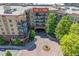 Aerial view of building with circular flower bed and fountain in front at 200 River Vista Dr # 236, Atlanta, GA 30339
