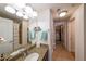 Well-lit bathroom featuring double sinks, a large mirror, and a shower with tile surround at 200 River Vista Dr # 236, Atlanta, GA 30339