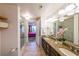 Bright bathroom featuring a granite vanity with double sinks, tile floors, and glass shower at 200 River Vista Dr # 236, Atlanta, GA 30339