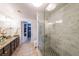 Elegant bathroom with a glass-enclosed shower featuring marble tiling, double vanity, and modern fixtures at 200 River Vista Dr # 236, Atlanta, GA 30339