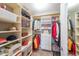 Organized walk-in closet with shelves, hanging space, and a small seating area at 200 River Vista Dr # 236, Atlanta, GA 30339