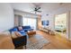 Bright living room features hardwood floors, a comfortable blue sectional, and access to a balcony with natural light at 200 River Vista Dr # 236, Atlanta, GA 30339