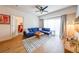 Inviting living room with hardwood floors, a cozy blue sofa, a decorative rug, and a well-lit atmosphere at 200 River Vista Dr # 236, Atlanta, GA 30339