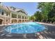 Large community pool with plenty of lounge chairs and shade trees perfect for summertime fun at 200 River Vista Dr # 236, Atlanta, GA 30339