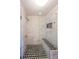 Modern walk-in shower with unique black and white geometric floor and a built-in bench at 200 River Vista Dr # 236, Atlanta, GA 30339