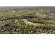 Aerial view of a planned community with golf course surrounded by woods at 3215 Oxleas Ct, Cumming, GA 30041