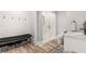Stylish bathroom featuring a glass shower, marble vanity, wood-look flooring, and bench seating at 3215 Oxleas Ct, Cumming, GA 30041