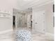 Open bathroom layout with a marble-walled glass shower, dual access to the main bedroom and marble floors at 3215 Oxleas Ct, Cumming, GA 30041