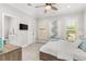 Neutral bedroom with plantation shutters, ceiling fan, and en suite bathroom at 3215 Oxleas Ct, Cumming, GA 30041