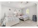 Bedroom featuring two beds with patriotic decor, carpeted floors, and natural light at 3215 Oxleas Ct, Cumming, GA 30041