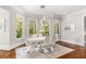 Dining room features a contemporary dining set with modern lighting and large windows overlooking the lush backyard at 3215 Oxleas Ct, Cumming, GA 30041