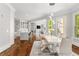 Bright dining room featuring modern table, chair set with modern lighting and views into kitchen and living room at 3215 Oxleas Ct, Cumming, GA 30041