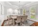 Formal dining room with tray ceiling, wainscoting, and shuttered windows at 3215 Oxleas Ct, Cumming, GA 30041