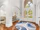 Bright foyer featuring hardwood floors, a grand archway, and views of the dining area at 3215 Oxleas Ct, Cumming, GA 30041