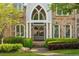 Elegant front entrance featuring arched double doors and manicured landscaping at 3215 Oxleas Ct, Cumming, GA 30041