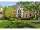 A lush front lawn and landscaped garden enhance the curb appeal of this luxury home at 3215 Oxleas Ct, Cumming, GA 30041