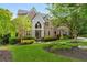 Stunning brick home with meticulously landscaped front yard and mature trees at 3215 Oxleas Ct, Cumming, GA 30041