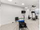 Well-lit home gym featuring modern exercise equipment and neutral carpeting at 3215 Oxleas Ct, Cumming, GA 30041
