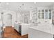 Gourmet kitchen with stainless steel appliances, custom cabinets, large quartz island, and hardwood flooring throughout at 3215 Oxleas Ct, Cumming, GA 30041