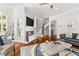 Spacious living area featuring a modern fireplace, staircase, and comfortable seating arrangement at 3215 Oxleas Ct, Cumming, GA 30041